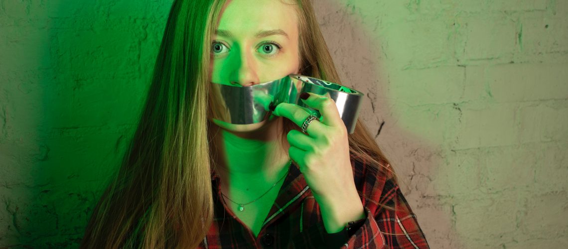 Woman with duct tape over her mouth